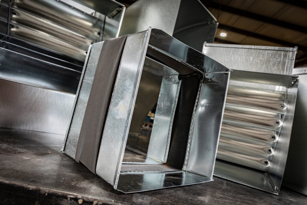 Custom-fabricated vibration isolation connector and rectangular duct fittings from DuctWorx, designed to minimize noise and vibration in HVAC duct systems while maintaining airflow efficiency.