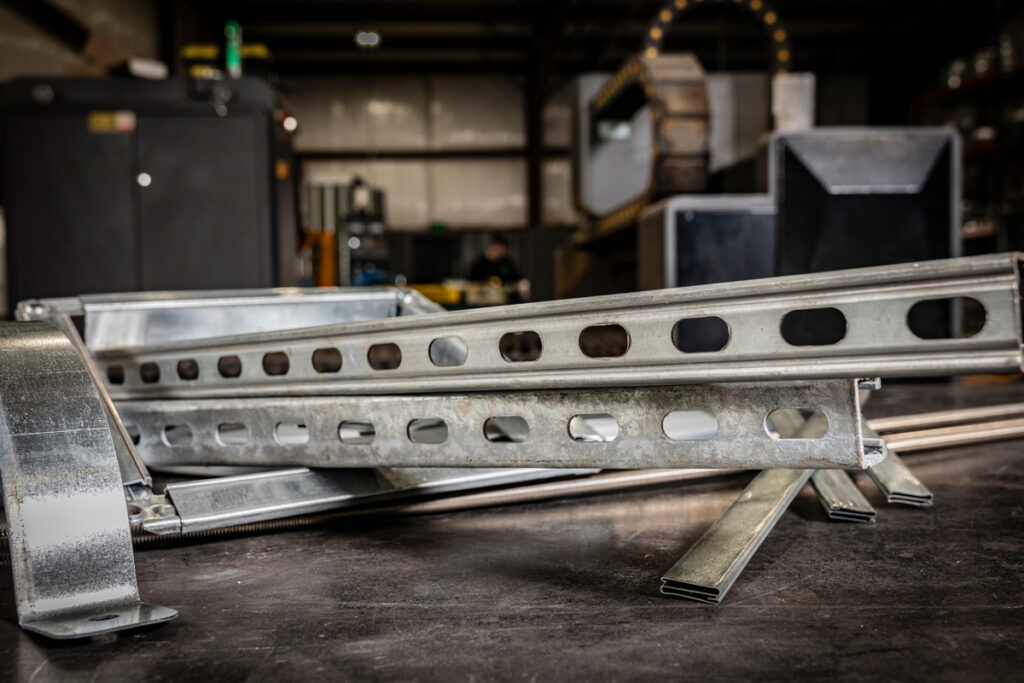 A collection of Unistrut framing channels, threaded rods and hangers used in HVAC duct support systems, fabricated by DuctWorx for safe and stable duct installation.
