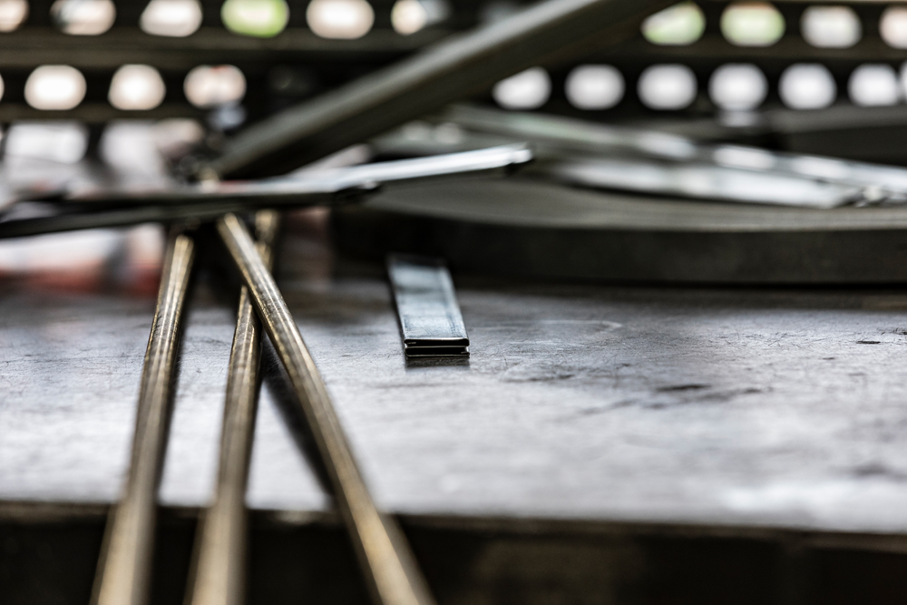 Close-up of duct hanging hardware at DuctWorx, including threaded rod, galvanized strap and flat cleats—core components for secure, code-compliant HVAC duct installation.