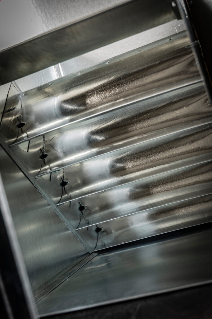 Inside view of a rectangular duct elbow with integrated turning vanes, custom-fabricated by DuctWorx to improve airflow efficiency and reduce system pressure loss in HVAC applications.